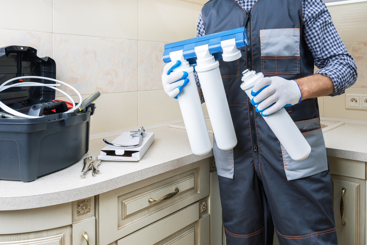 Man fitting water filters